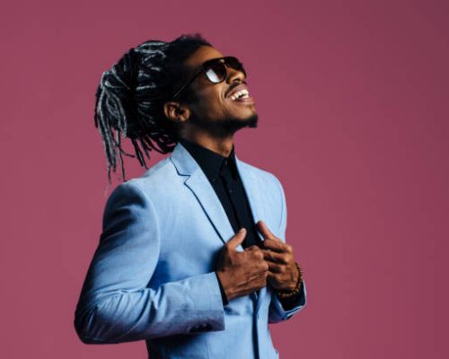 Portrait of a man with cool hair and sunglasses looking up