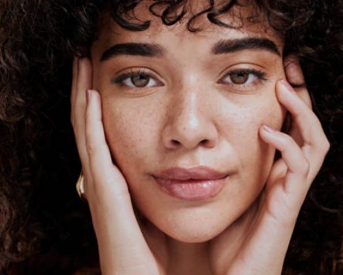 Beauty, portrait and natural face of black woman with healthy freckle skin texture touch. Aesthetic, facial and skincare cosmetic model girl touching cheeks for self love and wellness.