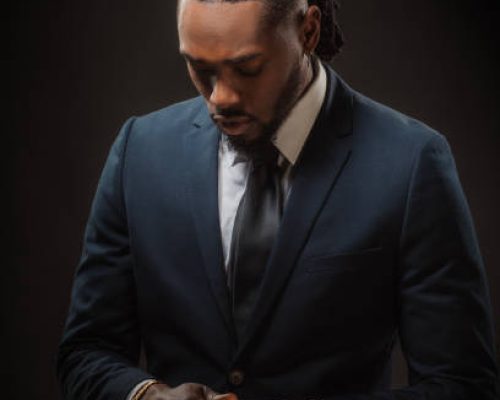Handsome elegant black male posing for studio portrait wearing a suit and tie
